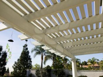 portico awning wooden sun shade ove back porch with slats and blue sky
