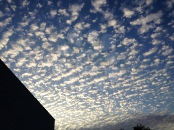 blue sky cirrocumulus astrocumulus clouds with modern building background