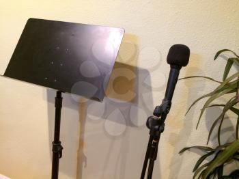 Sheet Music stand black color and microphone in studio