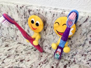 Fun yellow emoji smiling dental products toothbrush holders for kids