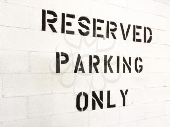 Reserved parking only sign black letters on white background in parking garage