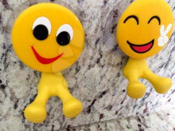 Happy fun yellow smiling emoji couple with peace sign dental toys