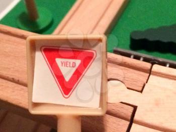 Yield street sign in toy city play town in miniature size