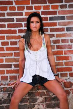 Young female model brunette pretty spring summer top with brick red background