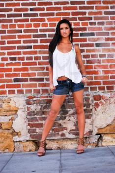 Young female model brunette pretty spring summer top with brick red background