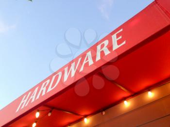Red canopy awning hardware store with yellow light bulbs abstract background with blue sky dusk