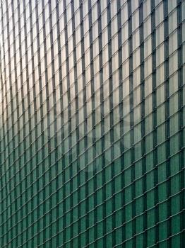 Chail link fence with green plastic slats modern design background element
