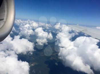 Blue sky and white clouds from airplane window