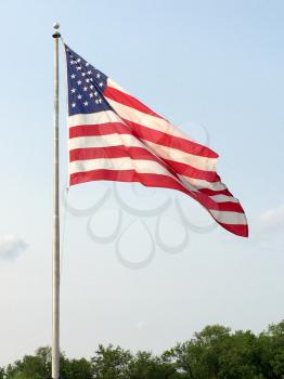 american flag big waving in wind with sky