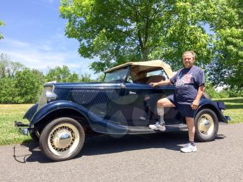 1934 Ford Roadster blue with proud owner man