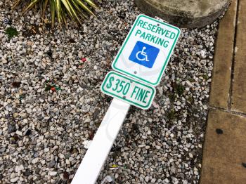 handicap parking sign on ground with post reserved parking