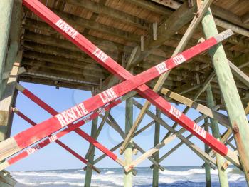 wood beach pier rescue lane signage with red cross