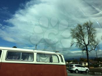volkswagen bus with blue sky and big white clouds