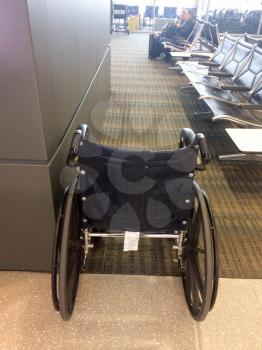 empty Wheelchair waiting area at airport in front of bright window