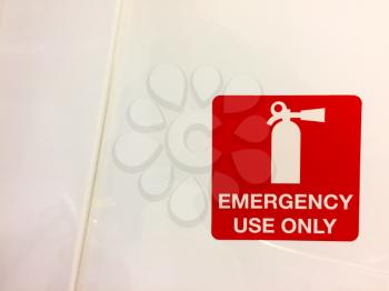 Emergency use only sign with a fire extinguisher