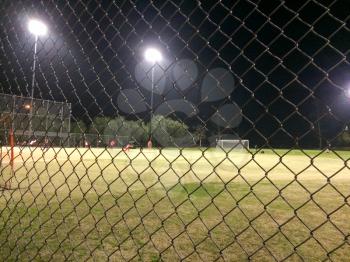 Night time soccer game at playing field outdoor with people and kids