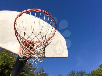 Basketball hoop with net outdoor court blue sky sunny play day