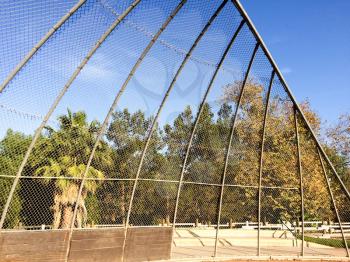 Baseball field backstop outdoor at park no people on sunny day
