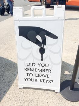 sign to leave car rental key with hand and key graphic