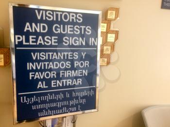 visitor check in registration sign at hospital reception lobby security