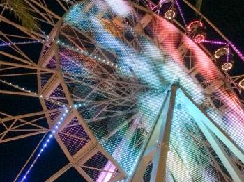 Ferris wheel illuminated at night colorful light motion scene