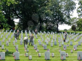 US Army soldiers planting American flags at Arlington National cemetary