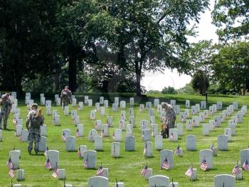 US Army soldiers planting American flags at Arlington National cemetary