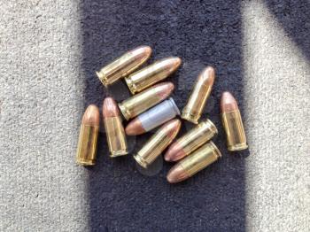 Bullets 9mm 40 caliber close up on table