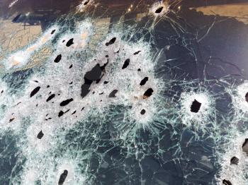 Automobile shot up bullet gun fire fight holes windshield broken glass
