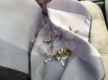 Automobile shot up bullet gun fire fight holes seat evidence crime