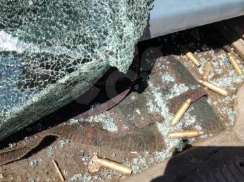 Automobile shot up bullet gun fire fight holes bullets evidence on floor
