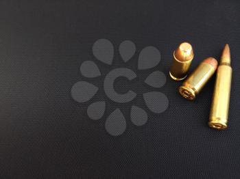 Bullets rifle handgun pistol firearm closeup on black backgound text space design element business card sign