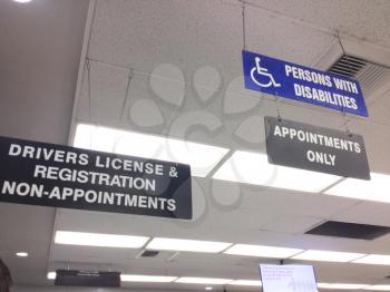 Department of motor vehicles DMV California America indoor office drivers license registration disabilities wheelchair sign