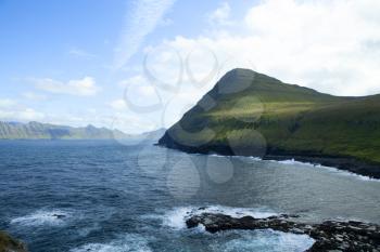 Surrounding mountains and sea near Gjogv with Kalsoy island on the background