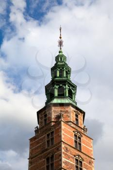 Copenhagen, Denmark - 12 September 2019: Tower of Rosenborg castle on a bright blue sky
