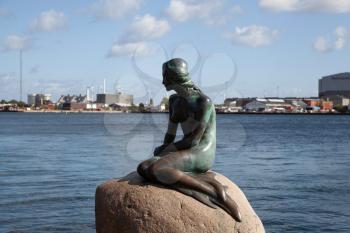 Copenhagen, Denmark - September 12, 2019: The Little Mermaid statue designed by Edvard Eriksen in Copenhagen on a bright summer day