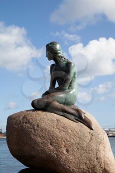 Copenhagen, Denmark - September 12, 2019: The Little Mermaid statue designed by Edvard Eriksen in Copenhagen on a bright summer day