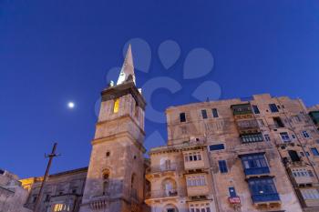 Valletta, Malta - 8 January 2020: St. Paul's Anglican Pro-Cathedral bell tower by night