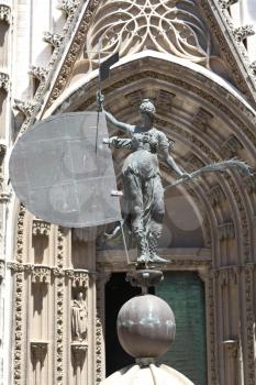 Seville, Spain - 29 July 2013: The Giraldillo statue replica in front of the Prince Cathedral Gate