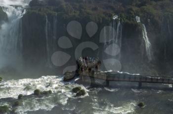 Tourists staying on Panoramic walkway overlooking Iguazu Falls, the border of Brazil and Argentina