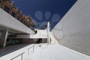 Barcelona, Spain - 22 June 2012: Modern minimalist architecture of CaixaForum with white walls and blue sky