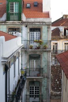 View of a house with tiled roof and windows decorated with azulejos in Alfama Lisbon, Portugal