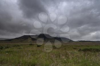 Typical Icelandic Landscape: hill, grass, gloomy sky