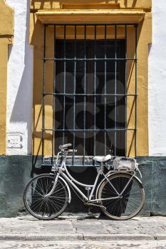 Vintage bicycle parked in front of the colorful wall