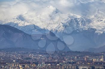 Turin and snowy Alps Skyline. View Over the city with rooftops and Sacra di San Michele.