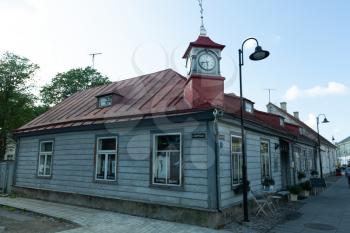 Kuressaare, Saaremaa, Estonia - 09 August 2019: wooden house with clock