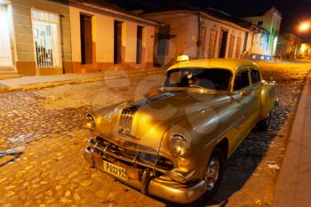 Trinidad, Cuba - 2 February 2015: Vintage taxi at night