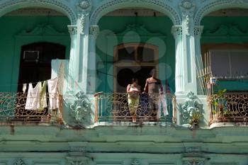 Havana, Cuba - 8 February 2015: Example of colonial architecture at Passeo Marti with two people standing on the balcony