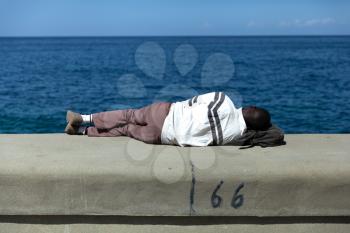 Havana, Cuba - 8 February 2015: Person sleeping on malecon