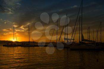 Silhouette of sails boats at sunset a the harbour